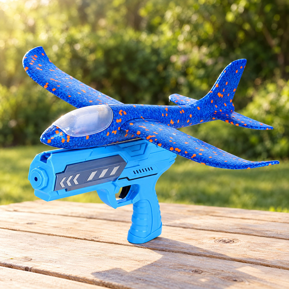 ORBITER blue foam glider and launcher on an outdoor table