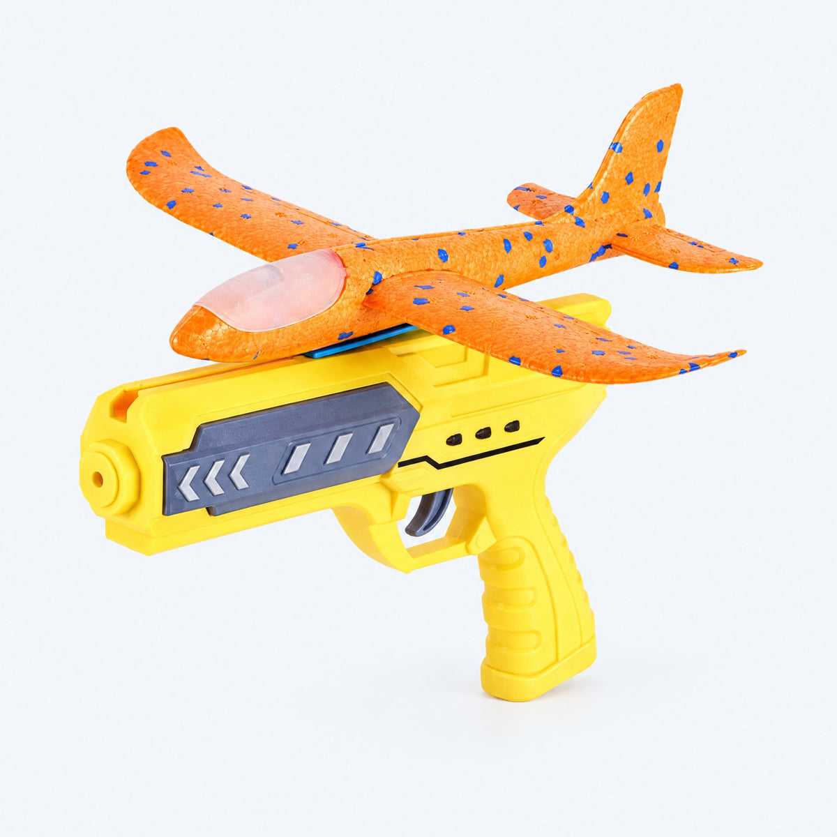 ORBITER orange foam glider and yellow launcher — studio view