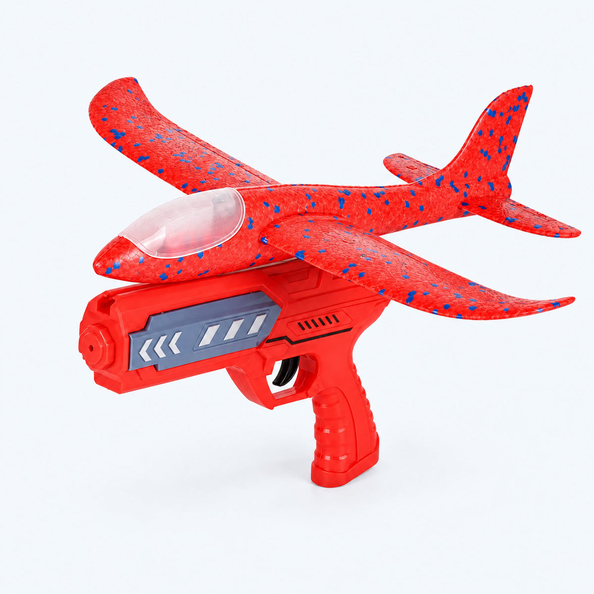 ORBITER red foam glider and red launcher — studio view